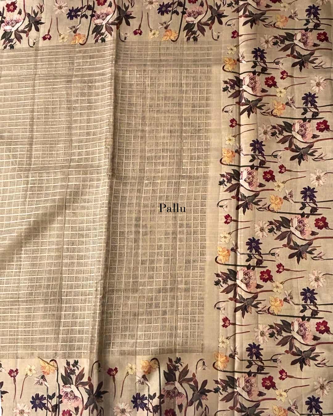 Beige kota doria saree with floral border and pallu