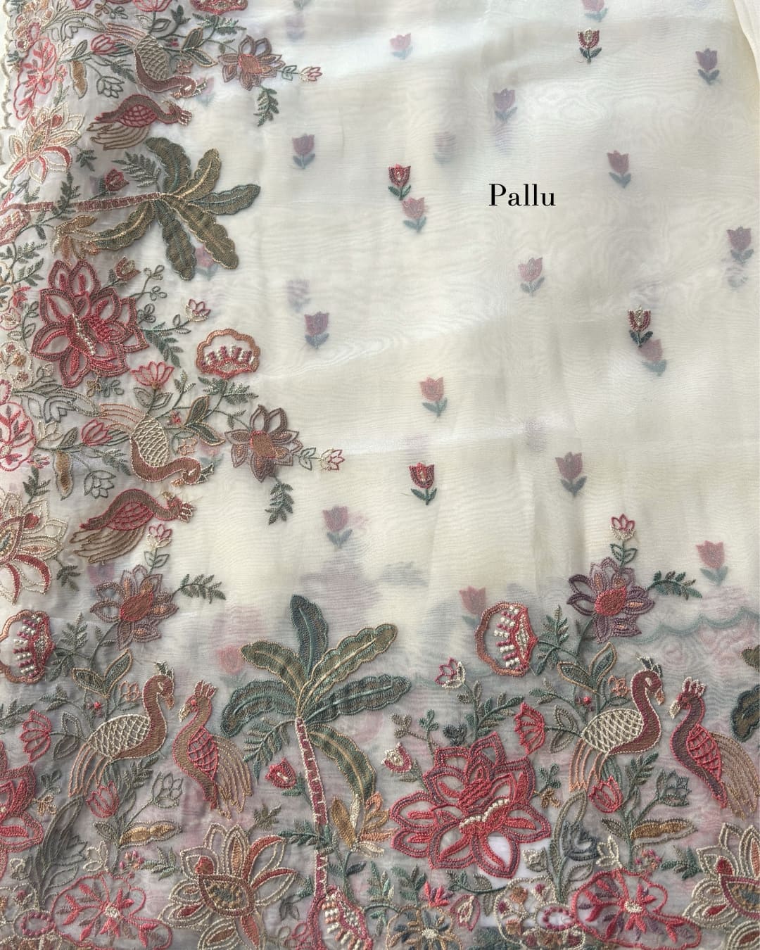 white tissue saree with floral embroidery work. 