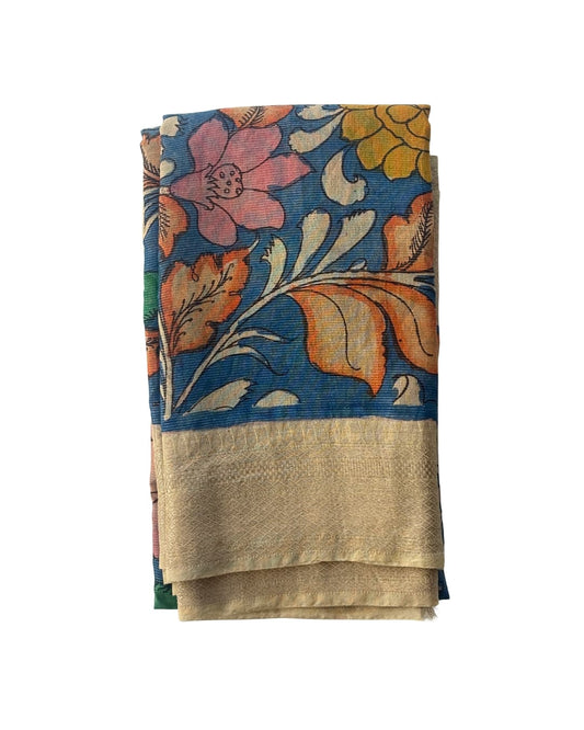 Floral kalamkari on tissue saree with a blue background and beige border.