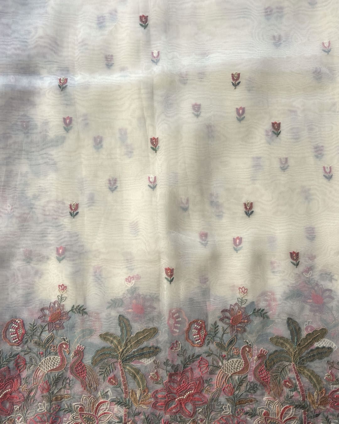 white tissue saree with floral embroidery work. 