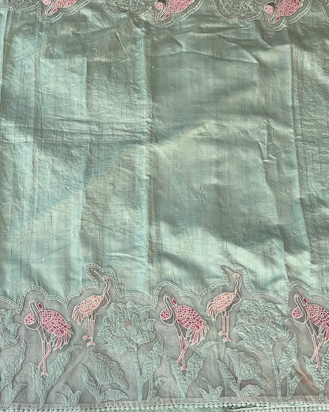 Pastel green applique work saree with a flamingo design

